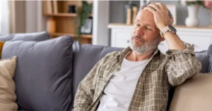 Man experiencing fatigue and sleep concerns related to hormone health